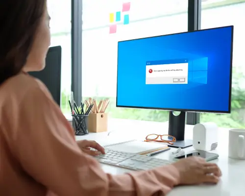 Femme utilisant un ordinateur avec un message d'erreur